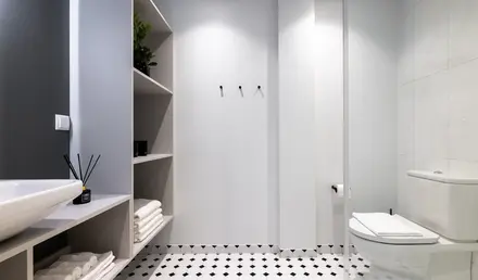 a bathroom with shelves and shelves
