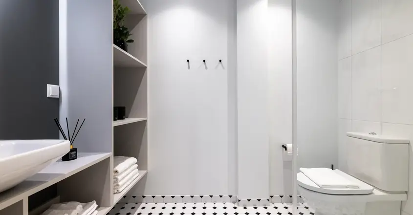 a bathroom with shelves and shelves