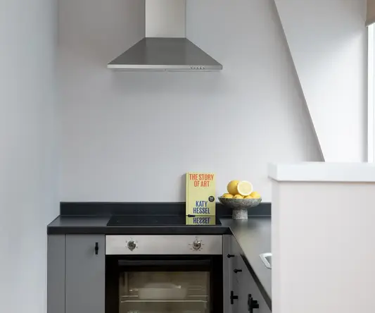 a kitchen with a bowl of lemons on a counter top