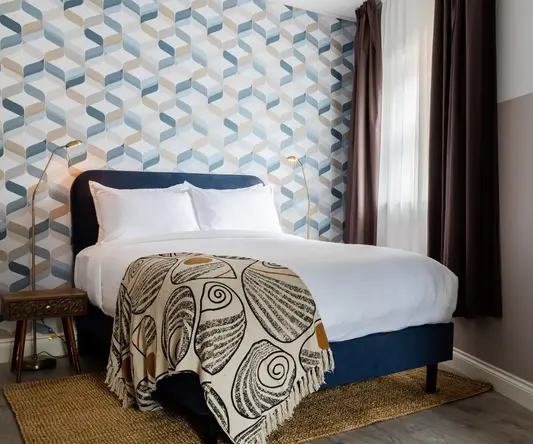 a bed with a blanket in a room