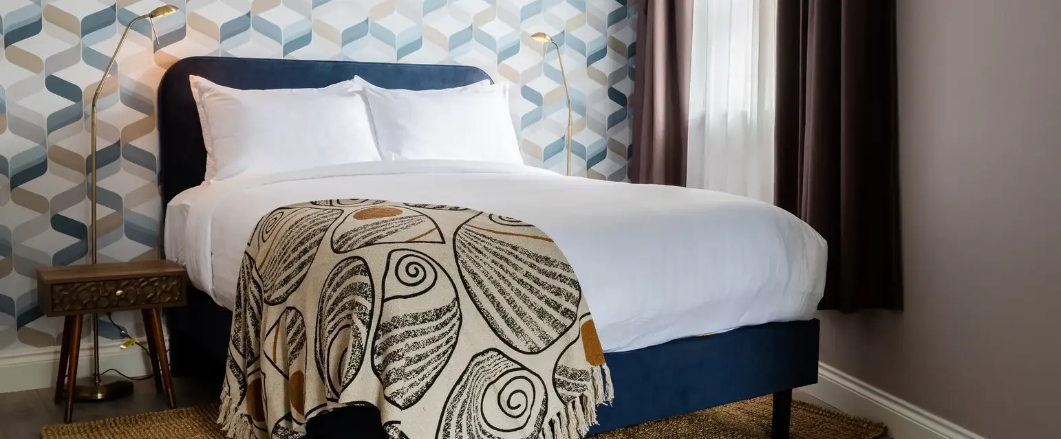 a bed with a blanket in a room