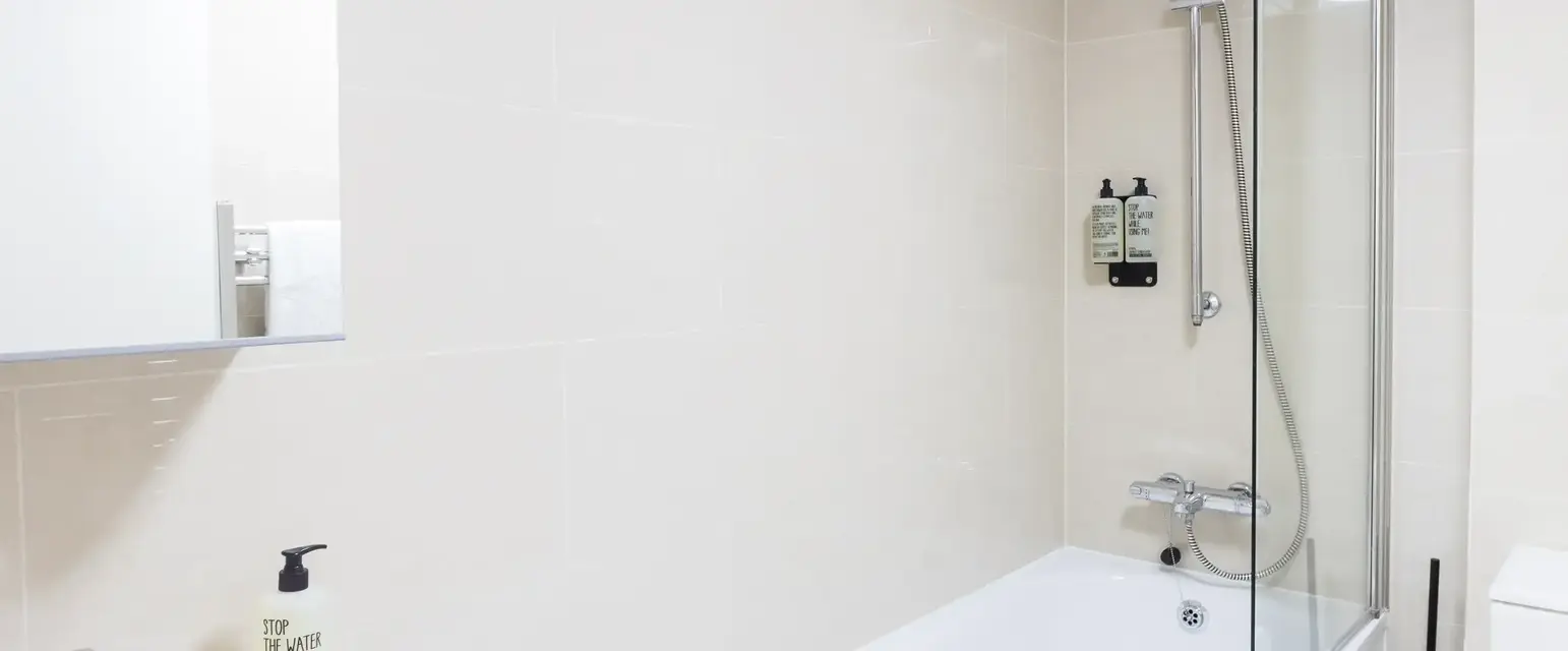 a bathroom with a bathtub and shower