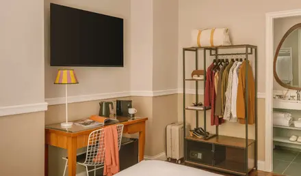 a room with a tv and a shelf