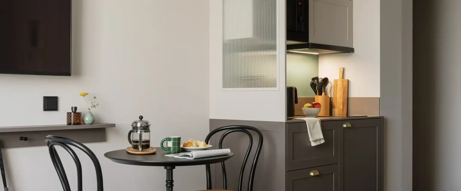 a kitchen with a table and chairs