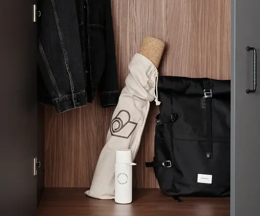 a black and white bag and jacket in a closet