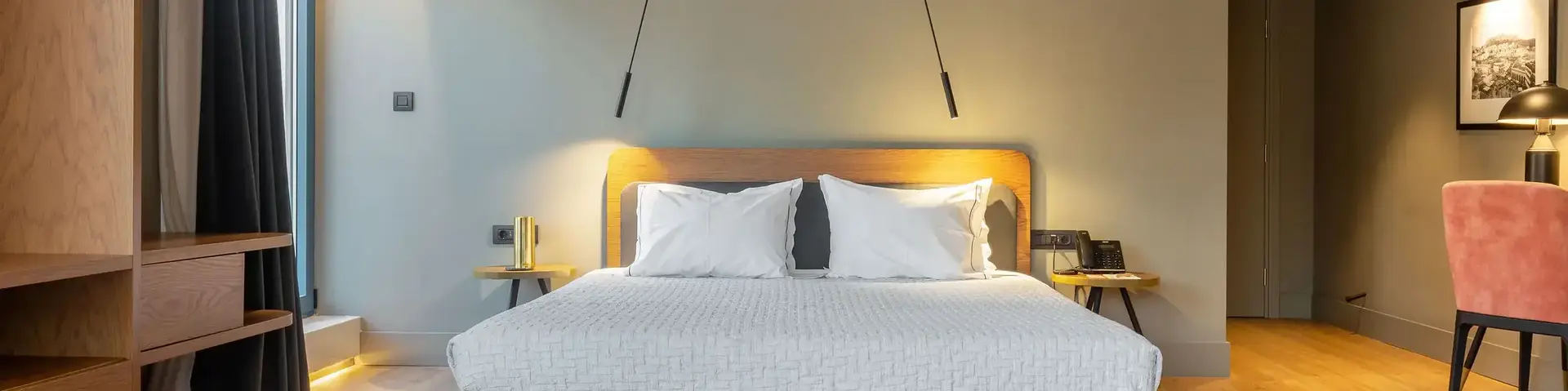 a bed with white pillows and wood floor