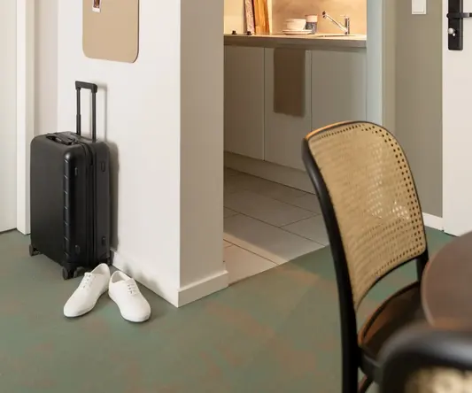 a kitchen with a suitcase and a table