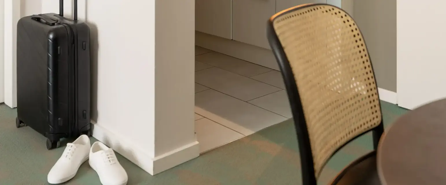 a kitchen with a suitcase and a table