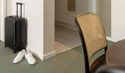 a kitchen with a suitcase and a table