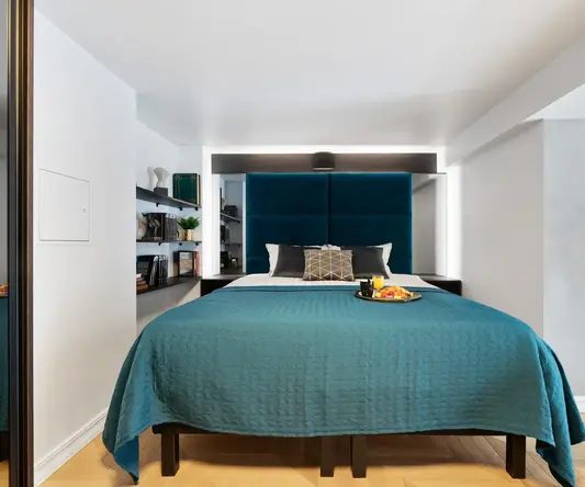 a bed with a tray of food on it