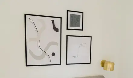 a bed with pillows and a lamp on the side