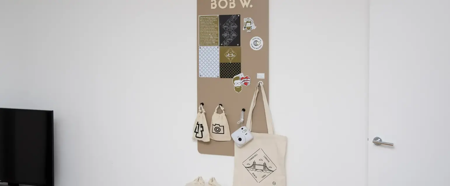 a board with a sign and bags on the wall