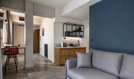 a living room with a couch and a kitchen