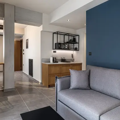 a living room with a couch and a kitchen