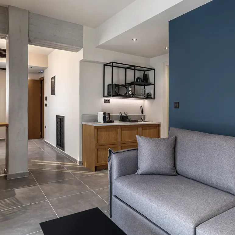 a living room with a couch and a kitchen