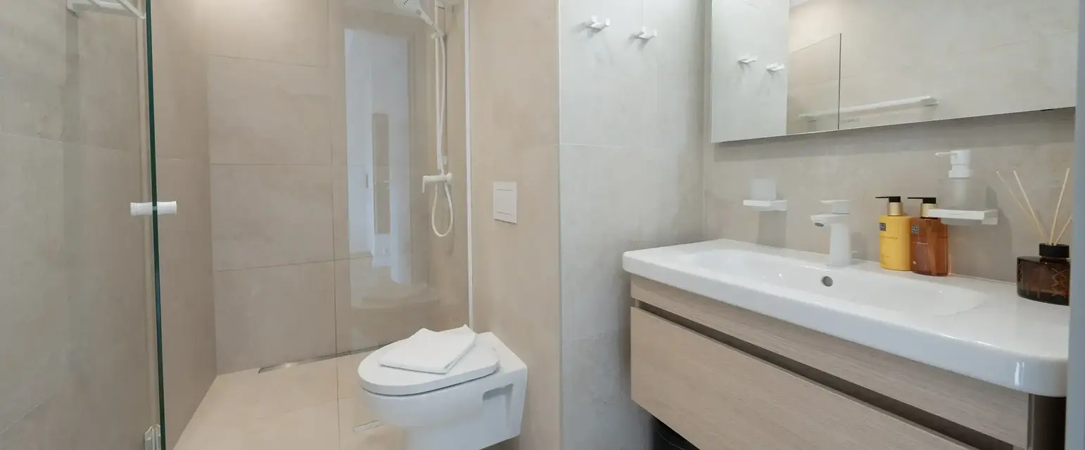 a bathroom with a shower and toilet