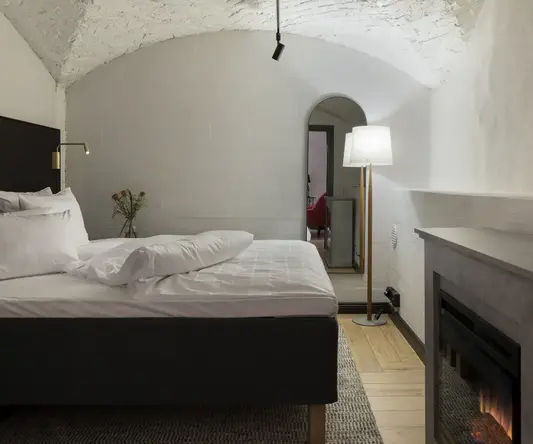 a bed with a fireplace in a room