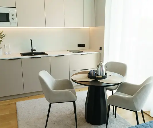 a kitchen with a table and chairs