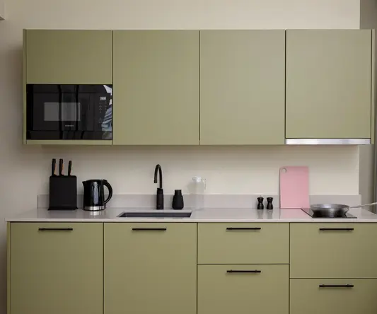 a kitchen with green cabinets