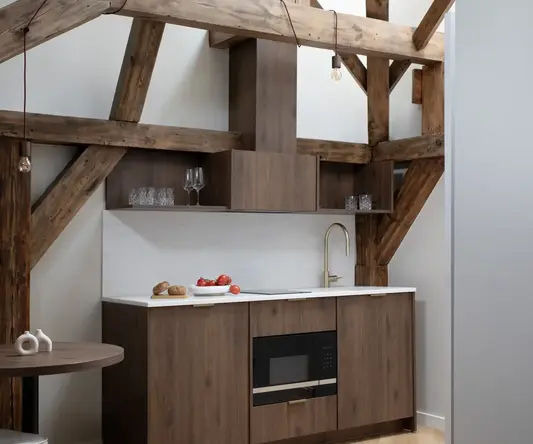 a kitchen with wood cabinets and a table