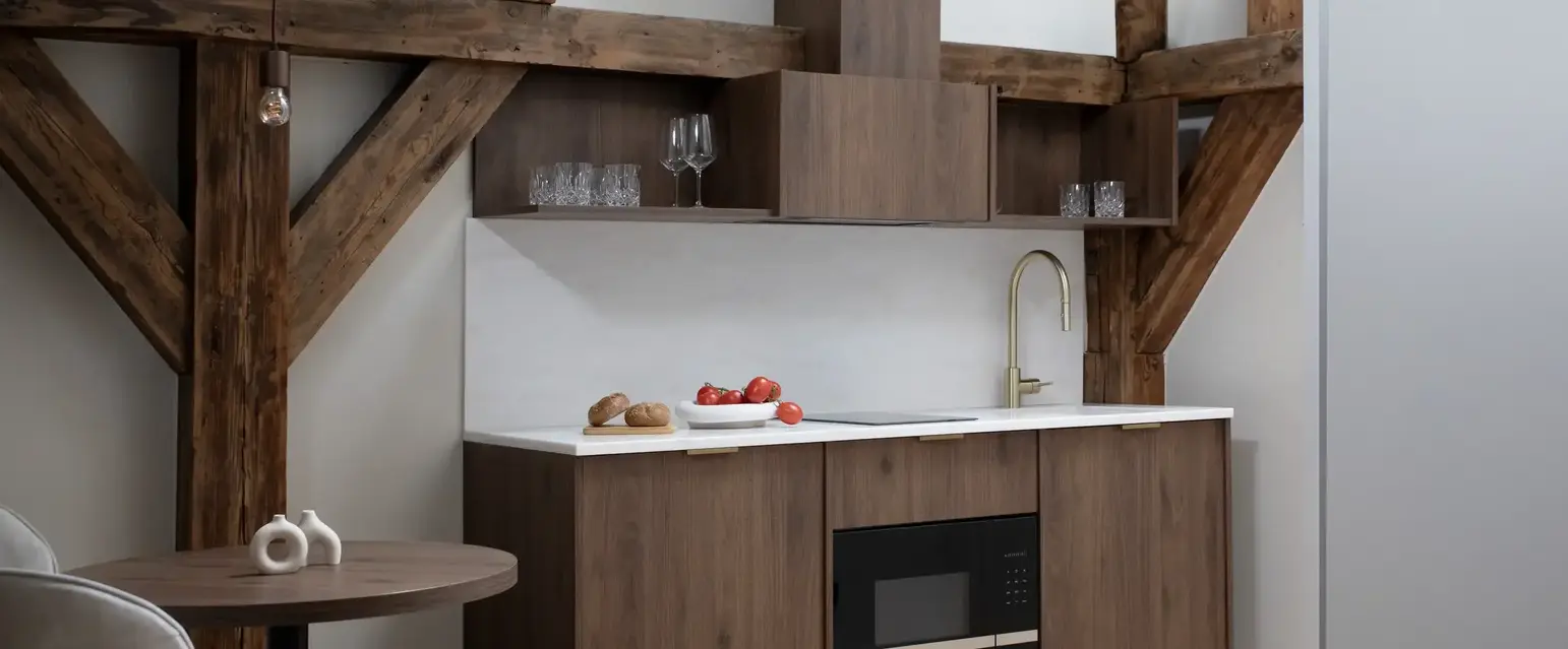 a kitchen with wood cabinets and a table
