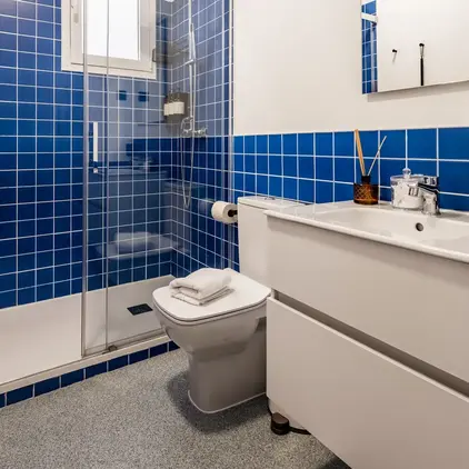 a bathroom with blue tiles