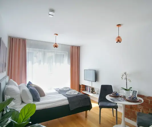 a room with a bed and a table and chairs