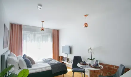 a room with a bed and a table and chairs