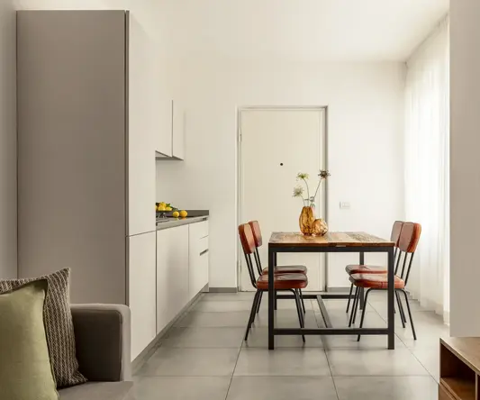 a dining table and chairs in a room