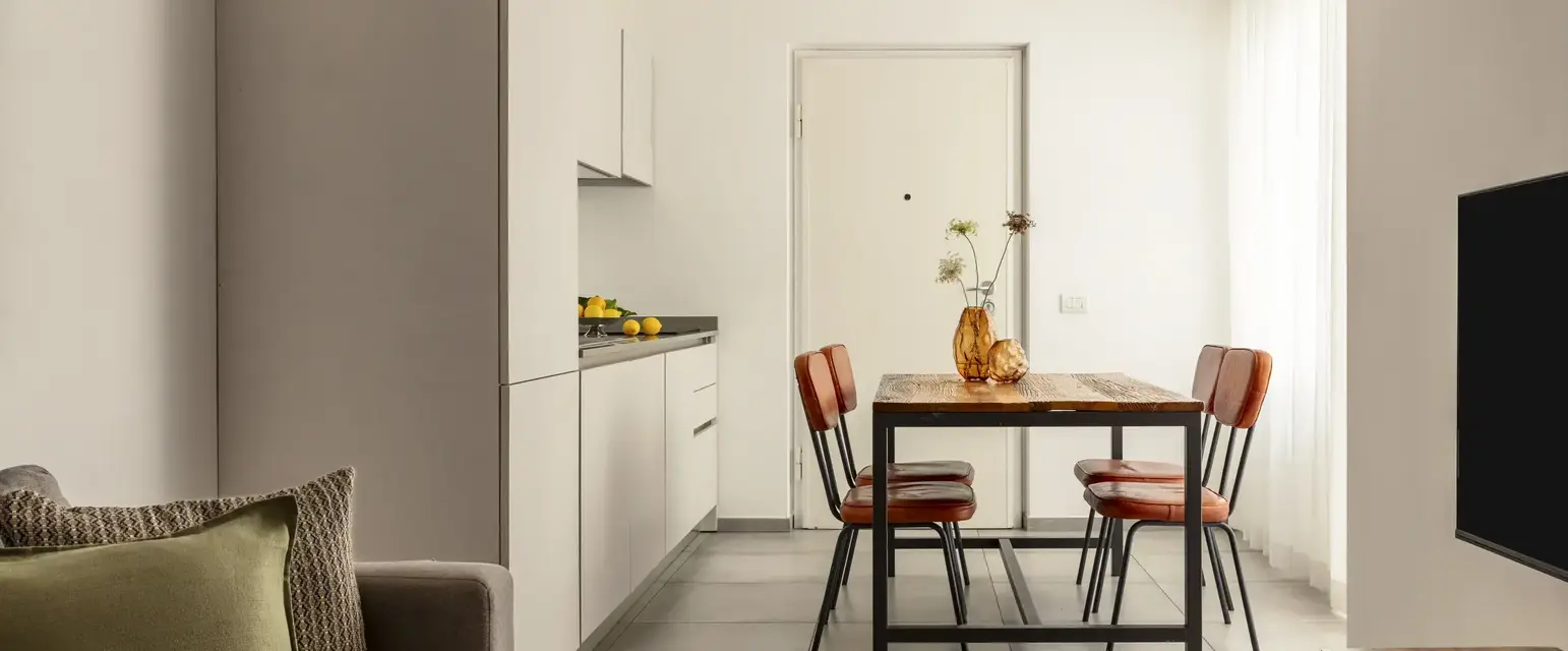 a dining table and chairs in a room