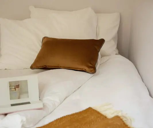 a bed with pillows and a book on it