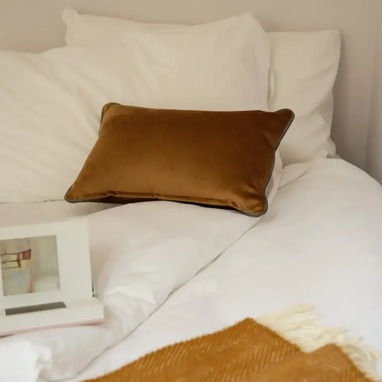 a bed with pillows and a book on it