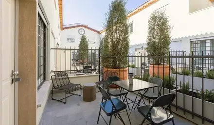a patio with a table and chairs