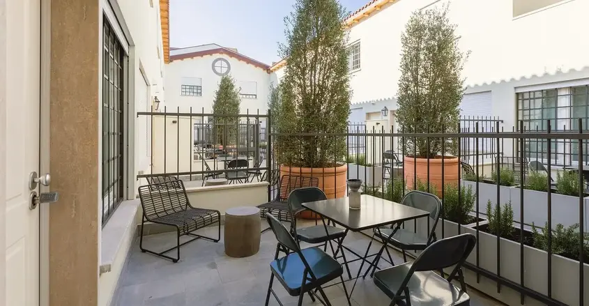a patio with a table and chairs