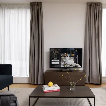 a living room with a television and a coffee table