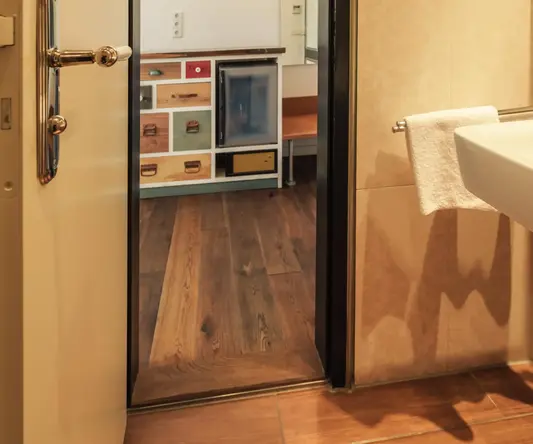 a bathroom with a door open