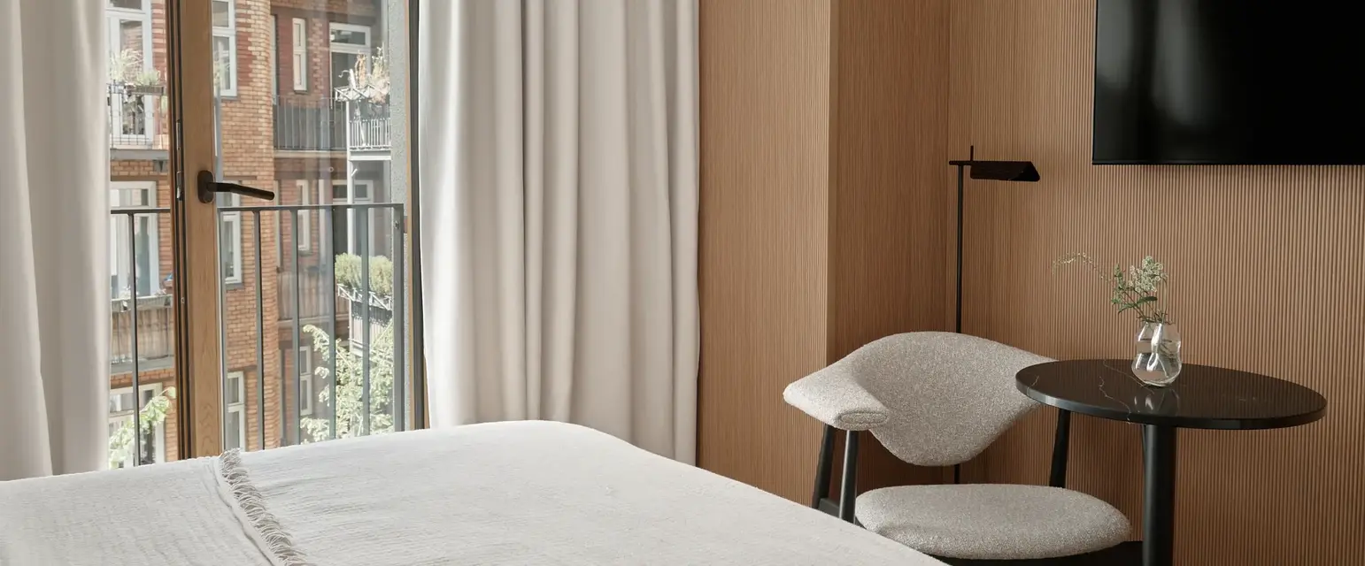 a room with a bed and a table and chair