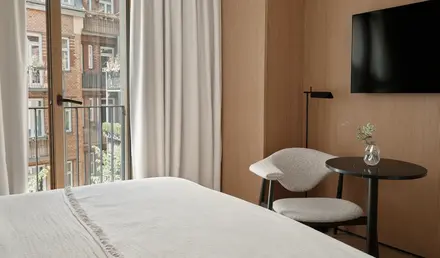 a room with a bed and a table and chair