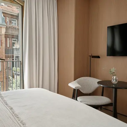 a room with a bed and a table and chair