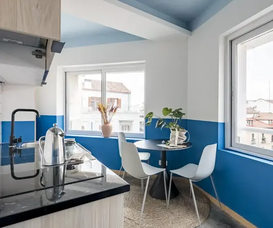 a kitchen with a table and chairs