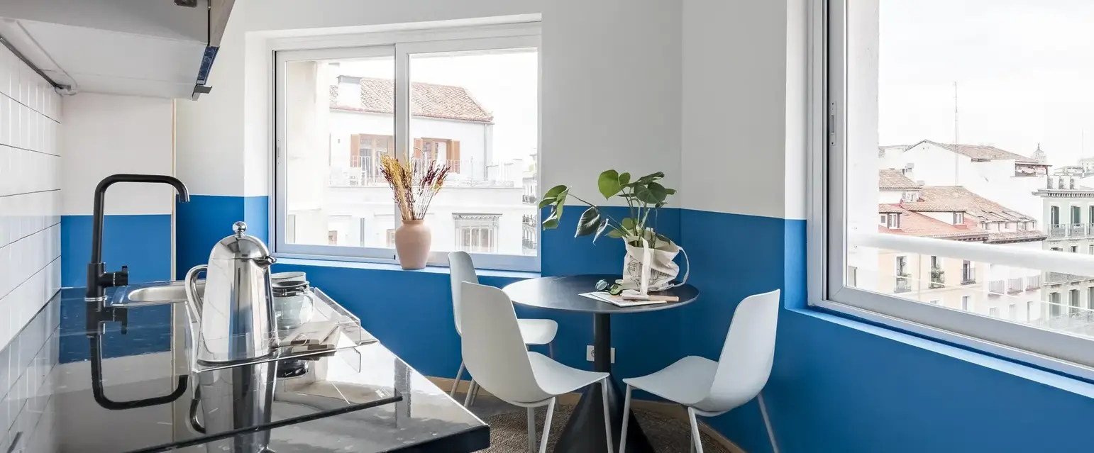 a kitchen with a table and chairs