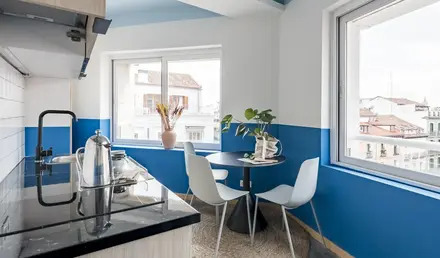 a kitchen with a table and chairs