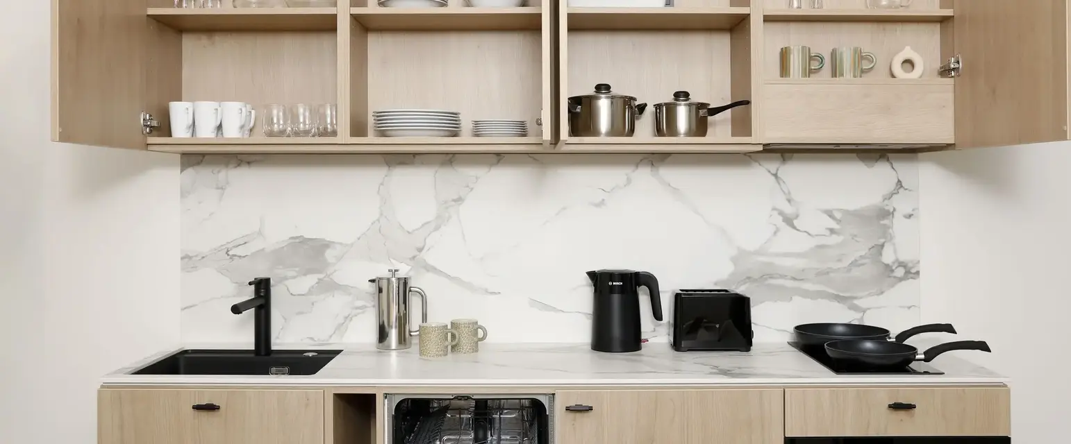 a kitchen with a counter top and shelves