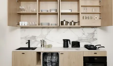 a kitchen with a counter top and shelves