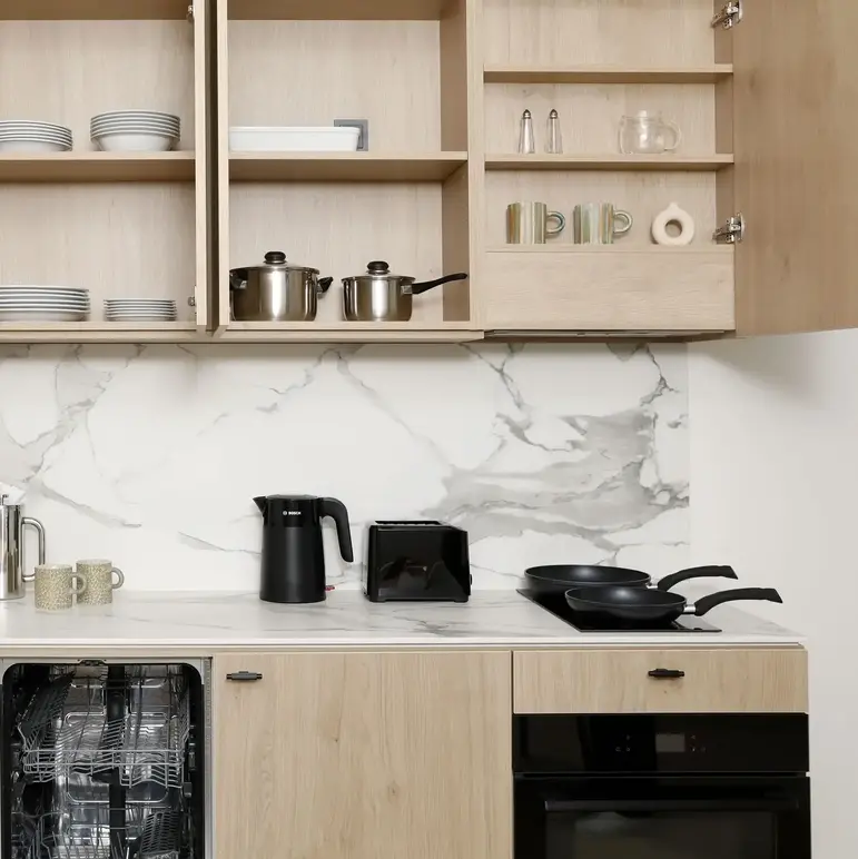 a kitchen with a counter top and shelves