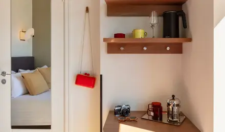 a shelf with coffee cups and a camera on it