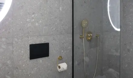 a shower with a round light fixture