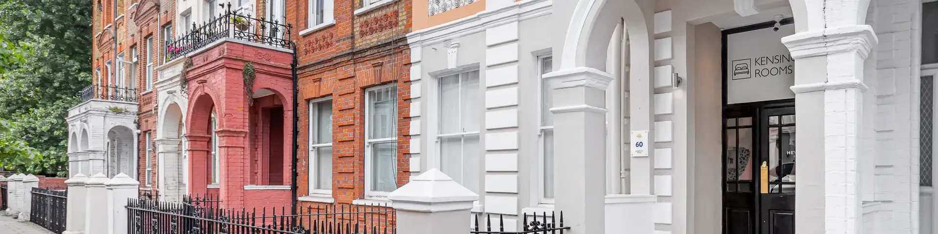 a row of buildings with a fence