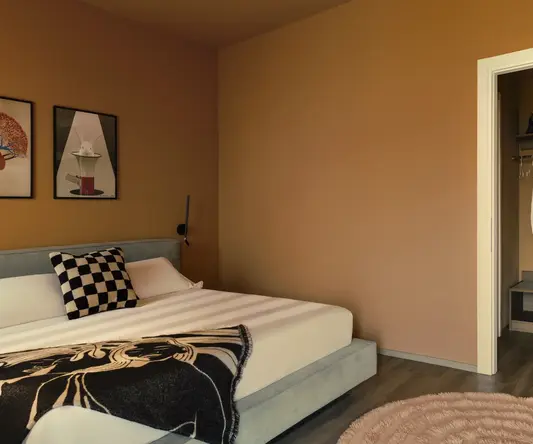 a bedroom with a bed and a rug