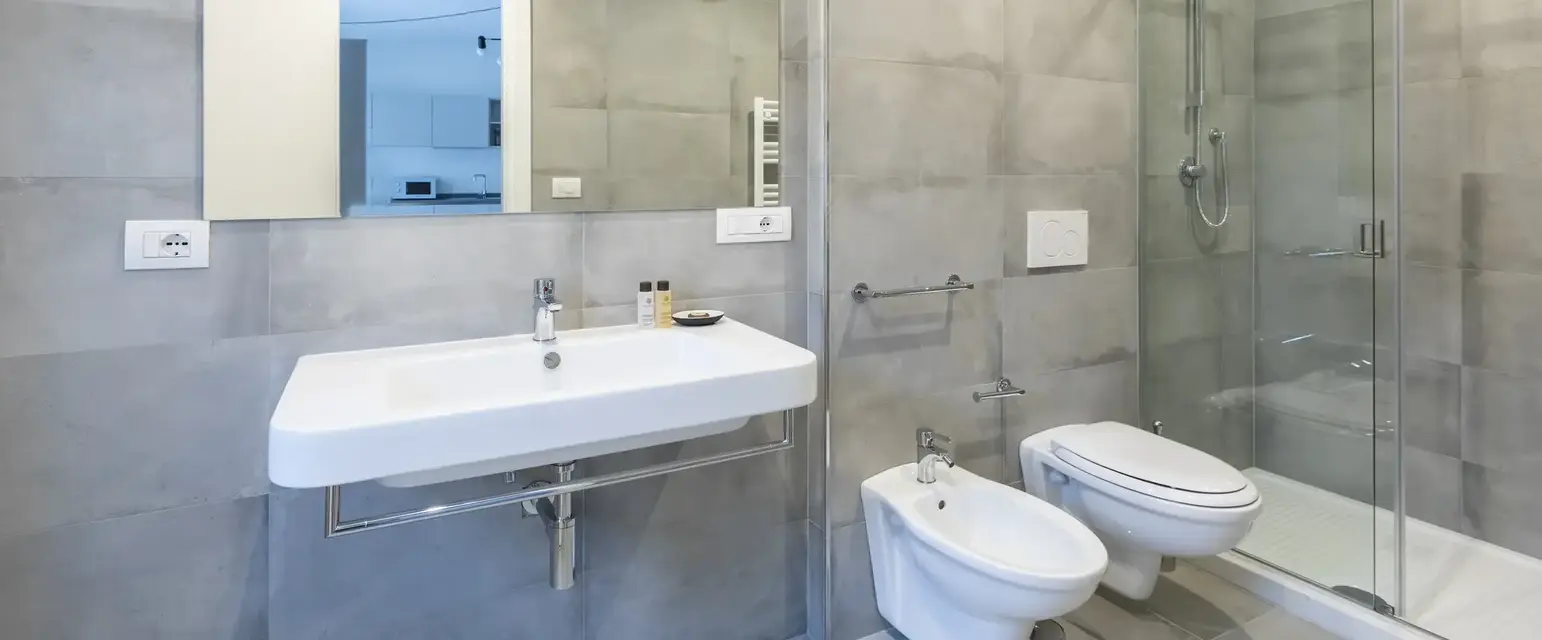 a bathroom with a shower and sink
